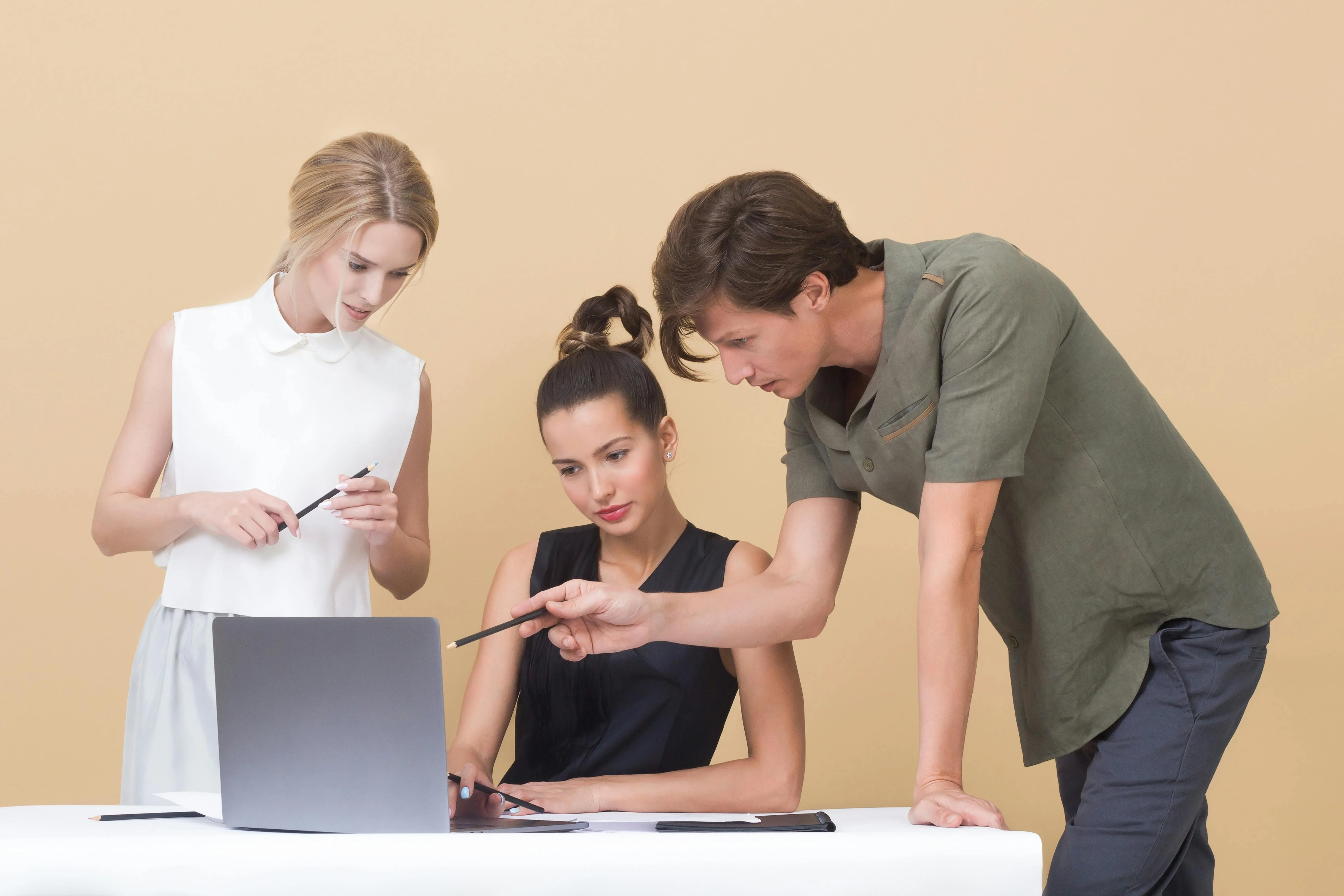 People working around a laptop